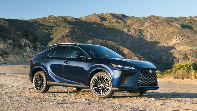 A dark blue Lexus RX350 parked on dirt in front of mountains