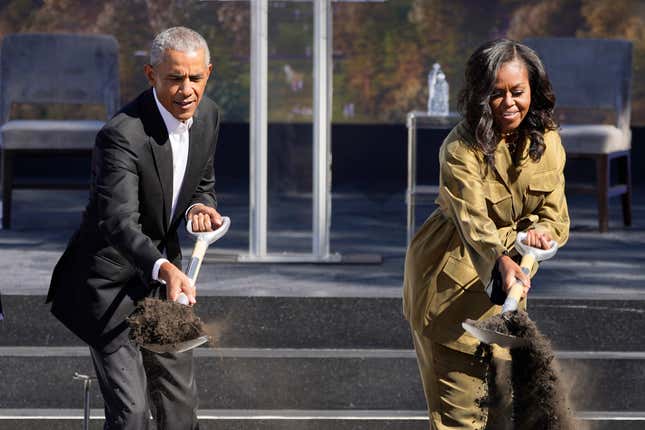 Former President Barack Obama, left, and former first lady Michelle Obama toss shovels of dirt during a groundbreaking ceremony for the Obama Presidential Center Tuesday, Sept. 28, 2021, in Chicago.