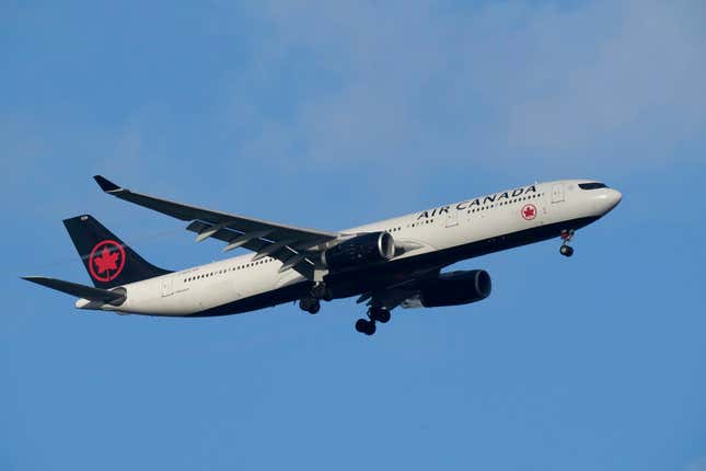 FILE - An Air Canada Airbus A330 approaches for landing in Lisbon, Saturday, Sept. 2, 2023. Air Canada says it has apologized to two women who were booted off a flight by security after protesting that their seats were smeared in vomit. The airline said Tuesday, Sept. 5, that the passengers “clearly did not receive the standard of care to which they were entitled.” (AP Photo/Armando Franca, File)