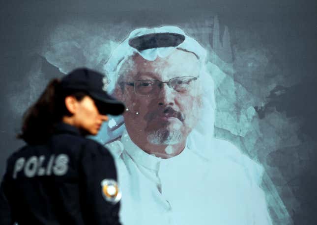 FILE - A Turkish police officer walks past a picture of slain Saudi journalist Jamal Khashoggi prior to a ceremony, near the Saudi Arabia consulate in Istanbul, Oct. 2, 2019. A Dubai-based broadcaster cut substantial portions of a recent episode of the satiric news program &quot;Last Week Tonight with John Oliver&quot; over references to Saudi Arabia&#39;s crown prince being implicated in the 2018 killing of Washington Post columnist Jamal Khashoggi. (AP Photo/Lefteris Pitarakis, File)