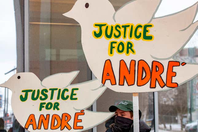 Black Lives Matter Activists hold signs outside the Franklin County Common Pleas Courthouse during the arraignment of Adam Coy, the former Columbus Police officer who shot and killed Andre Hill, in Columbus, Ohio on February 5, 2021.