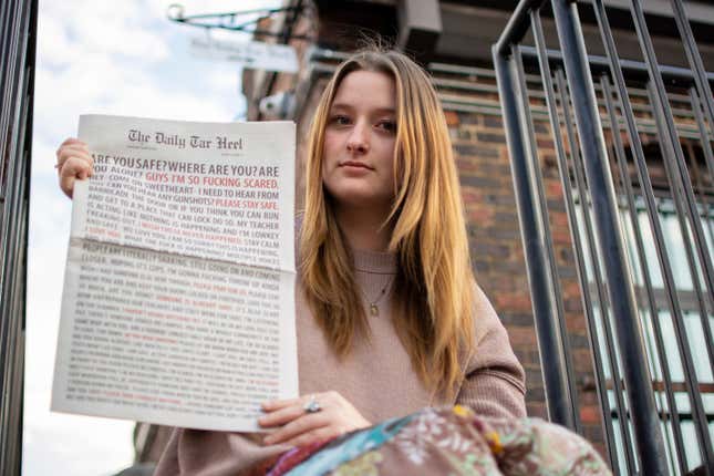 Emmy Martin, Editor in Chief of The Daily Tar Heel, the student newspaper of the University of North Carolina at Chapel Hill, poses with a copy of the Aug. 30 paper outside of the newsroom on Monday, Oct. 9, 2023, in Chapel Hill, N.C. (Samantha Lewis via AP)