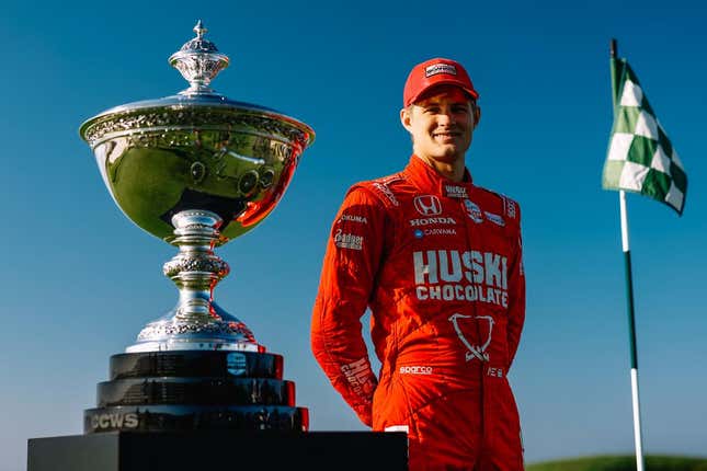 Marcus Ericsson poses next to the Astor Cup ahead of the 2022 IndyCar season finale.