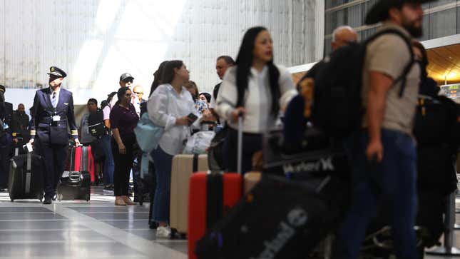 Travelers gather with their luggage in the departures area of the international terminal at Los Angeles International Airport (LAX) on August 31, 2023 in Los Angeles, California.