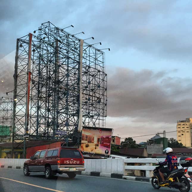 Image for article titled Photos: Dismantled billboards, ghostly scaffolds as a city braces for a typhoon