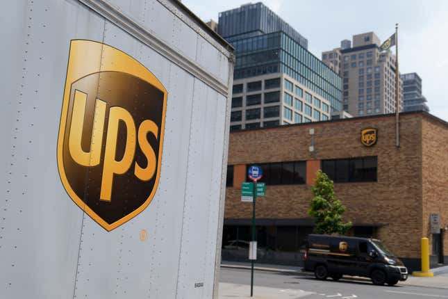 FILE - A delivery vehicle passes by a UPS depot, Thursday, June 29, 2023, in New York. UPS has received an air cargo contract from the United States Postal Service, significantly expanding on an existing partnership between the two. UPS said Monday, April 1, 2024, that it will become USPS&#39;s primary air cargo provider and move the majority of its air cargo in the U.S. following a transition period.(AP Photo/John Minchillo, File)