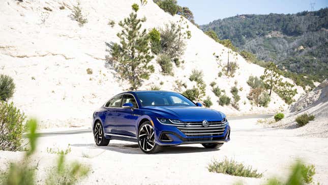 A deep blue 2023 VW Arteon parked in the mountains