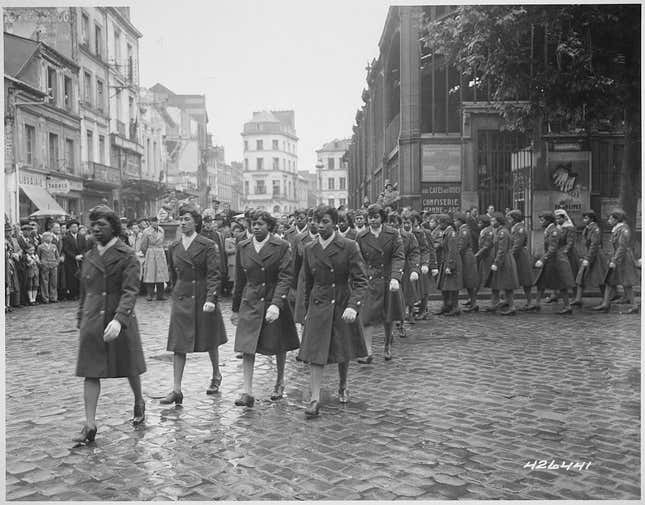 Members of the 6888th Central Postal Directory Battalion participate in a parade ceremony in honor of Joan d’Arc at the marketplace where she was burned at stake in 1945.