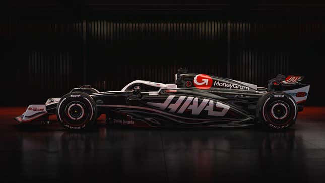 A side photo of the black and white Haas F1 car. 