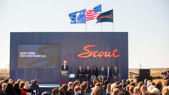 A podium at the Scout Motors factory with a group of speakers