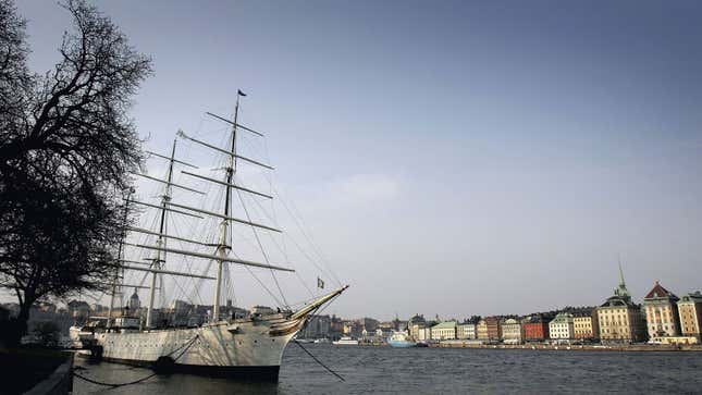 A photo of the waterfront in Stockholm with a tall ship at the front. 