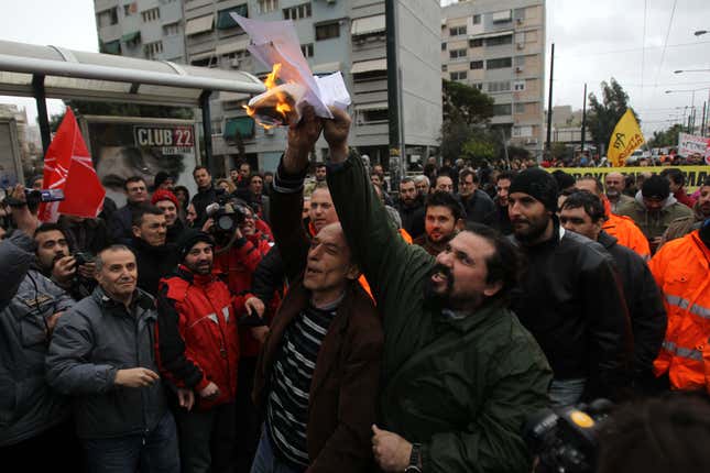 Metro workers burn documents outside Aghios Antonios station in western Athens. Striking Athens metro workers returned to the job Friday, hours after the Greek government dispatched riot police to a transit depot.