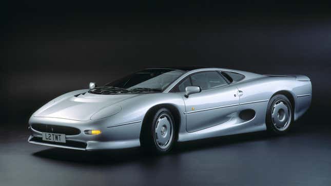 A silver XJ220 in a studio