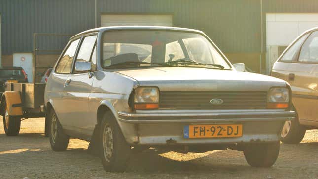 A 1979 Ford Fiesta parked in an industrial lot.