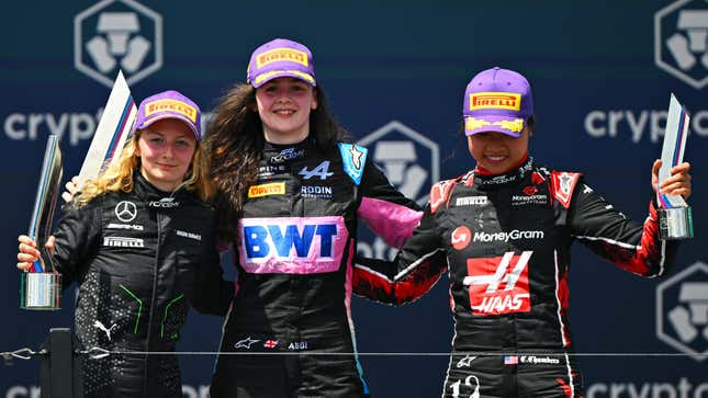 Race winner Abbi Pulling of Great Britain and Rodin Motorsport (9), Second placed Doriane Pin of France and PREMA Racing (28) and Third placed Chloe Chambers of United States and Campos Racing (14) celebrate on the podium during race 1 during Round 2 Miami of the F1 Academy at Miami International Autodrome on May 04, 2024 in Miami, Florida