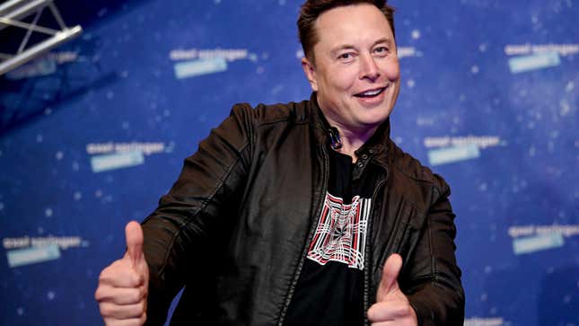 Elon Musk smiles and gives two thumbs up.