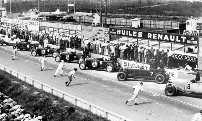 Historic photo of drivers racing to their cars at Le Mans