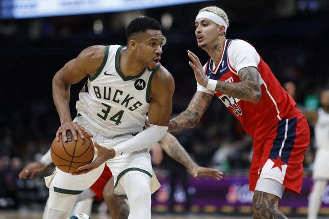 Nov 20, 2023; Washington, District of Columbia, USA; Milwaukee Bucks forward Giannis Antetokounmpo (34) drives to the basket as Washington Wizards forward Kyle Kuzma (33) defends in the fourth quarter at Capital One Arena.