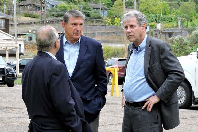 U.S. Sen. Joe Manchin, D-W.Va., center, and U.S. Sen. Sherrod Brown, D-Ohio, right, speak with Cleveland-Cliffs CEO Lourenco Goncalves during a visit to Cleveland-Cliffs in Weirton, W.Va., Sept. 26, 2023. Cleveland-Cliffs announced Thursday, Feb. 15, 2024, that it is shutting down the northern West Virginia tin production facility indefinitely and plans to lay off 900 workers after the International Trade Commission voted against imposing tariffs on tin imports. (Craig Howell /The Weirton Daily Times via AP)