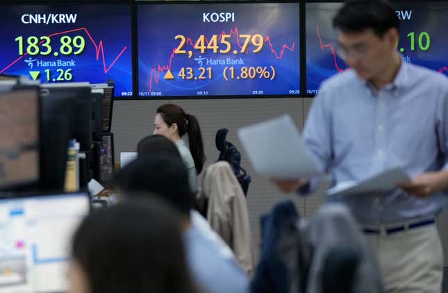 Currency traders work near the screen showing the Korea Composite Stock Price Index (KOSPI), center, at the foreign exchange dealing room of the KEB Hana Bank headquarters in Seoul, South Korea, Wednesday, Oct. 11, 2023. Shares are higher in Asia, tracking Wall Street gains following an easing of pressure from the bond market. (AP Photo/Ahn Young-joon)