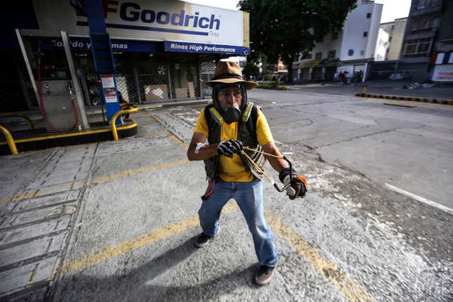 A protestor confronts members of the National Bolivarian Guard