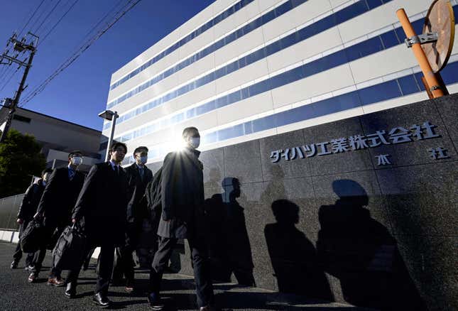 Japanese transport ministry officials arrive for the headquarters of Daihatsu Motor in Ikeda, Osaka, Thursday, Dec. 21, 2023. Japanese transport ministry officials inspected Toyota subsidiary Daihatsu on Thursday, one day after officials announced it was suspending the small car unit&#39;s shipments of all vehicles in and outside Japan after an investigation found improper testing involving 64 models. (Kyodo News via AP)