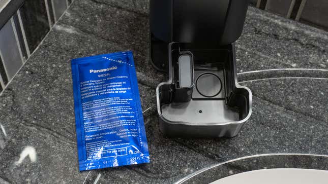 The Arc6's charging dock opened to reveal a compartment for cleaning solution.