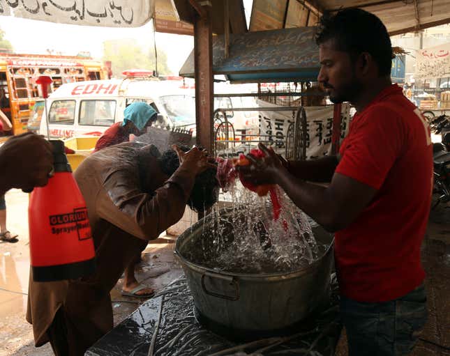 Rescue workers spray people on May 22.