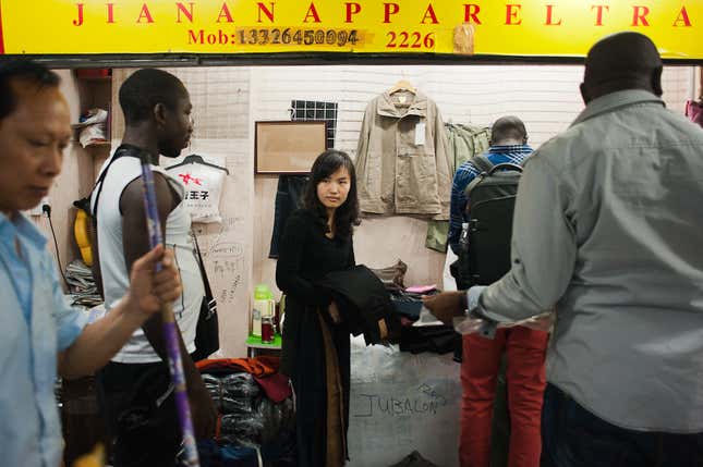 Traders discuss a shipment of jeans at Canaan Market in Guangzhou, China.