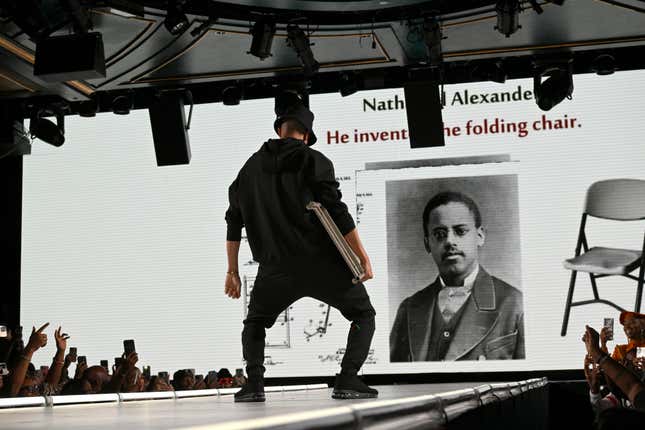 NEW YORK, NEW YORK - SEPTEMBER 08: Affion Crockett carries a folding chair - a recall to the viral meme of a folding chair wielding man who aided an Alabama dock worker who was attacked in a massive brawl - at the Actively Black fashion brand’s The Black Mixtape 2 runway show at Sony Hall on September 08, 2023 in New York City.