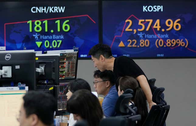 Currency traders watch monitors near the screens showing the Korea Composite Stock Price Index (KOSPI), top right, at the foreign exchange dealing room of the KEB Hana Bank headquarters in Seoul, South Korea, Wednesday, Aug. 30, 2023. Asian shares rose Wednesday, boosted by a Wall Street rally that came on positive reports on consumer confidence and job openings.(AP Photo/Ahn Young-joon)