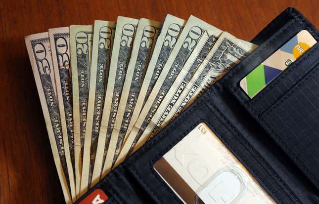 FILE - In this June 15, 2018, file photo, cash is fanned out from a wallet in North Andover, Mass. The holidays are a time when travel, gift buying and family outings are abundant. The season can lead you to feel pressured to spend more than you usually would. For this reason, it’s important to have financial boundaries in place to safeguard your finances. The steps that can help you establish and uphold financial boundaries include creating a financial plan for 2024, learning how to say no, acknowledging any guilt that comes up and exploring your beliefs around holiday spending. (AP Photo/Elise Amendola, File)