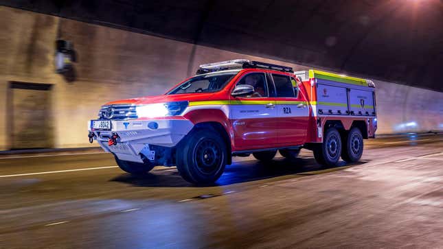 Image for article titled This Six-Wheeled Toyota Hilux Is Designed to Fight EV Fires