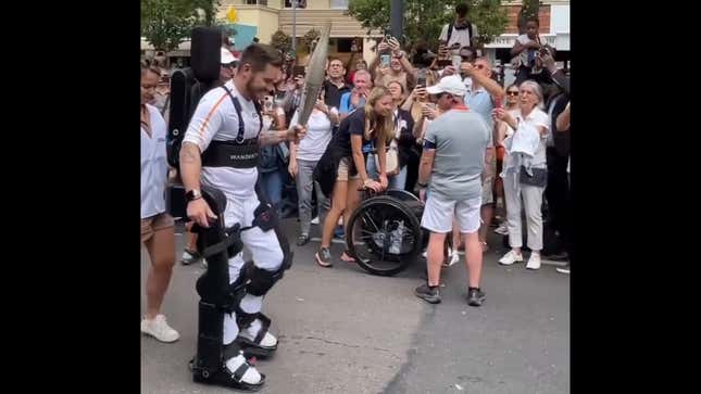 Image for article titled Paraplegic Tennis Player Pilots A Mech To Carry The Olympic Torch