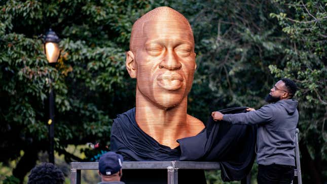 In this Thursday, Sept. 30, 2021, file photo, a sculpture of George Floyd, one of three sculptures as part of the “SEEINJUSTICE” art exhibition that also feature the likenesses of Breonna Taylor and John Lewis, is unveiled as Floyd’s brother Terrence, second from left, looks at Union Square in the Manhattan borough of New York. The statue honoring Floyd was vandalized on Sunday, Oct. 3, police said.