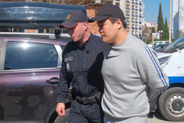 FILE - Montenegrin police officers escort South Korean citizen, Terraform Labs founder Do Kwon in Montenegro&#39;s capital Podgorica, March 24, 2023. A court in Montenegro has ruled that Do Kwon should be extradited to the United States to face fraud charges rather than to his native South Korea, a court official in the Balkan Country said Thursday Feb. 22, 2024. Do Kwon, 32, was arrested nearly a year ago in Montenegro on an international arrest warrant in connection with a $40 billion crash of Terraform Labs&#39; cryptocurrency, which devastated retail investors around the world. (AP Photo/Risto Bozovic, File)