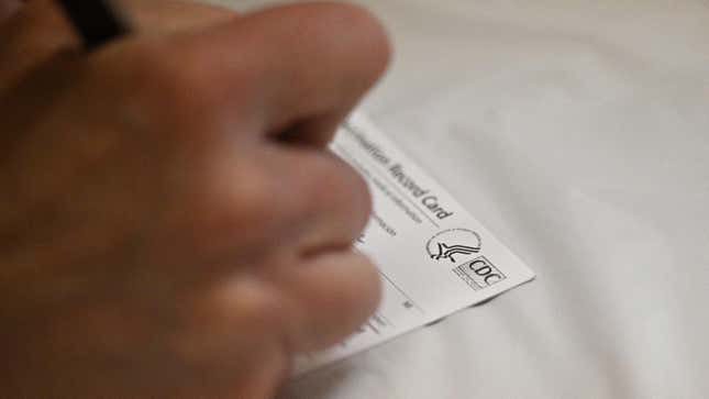 A person filling out a Centers for Disease Control and Prevention vaccination card; used here as stock photo.