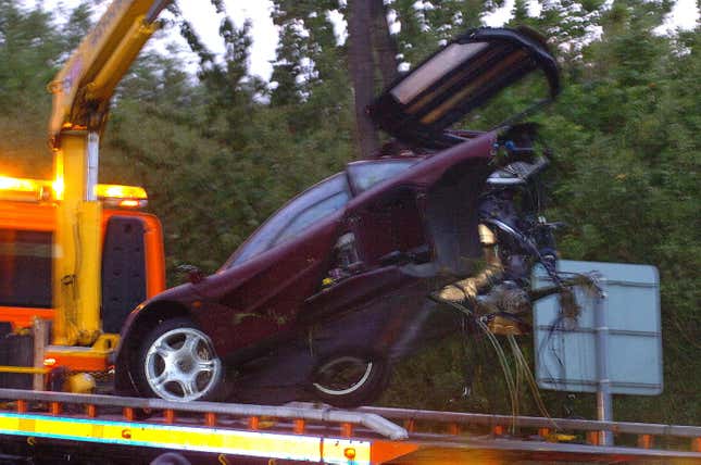 The front half of Rowan Atkinson's purple McLaren F1 being hoisted onto a tow truck after he crashed