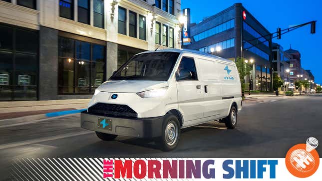 A photo of an Electric Last Mile van driving through a city at night. 