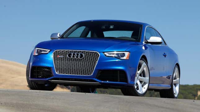 A front 3/4 view of the Audi RS5 Coupe in bright blue parked on a track