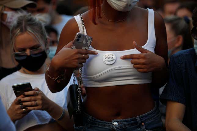 In this Nov. 7, 2020, file photo, a woman displays a button that says “Black votes count” while celebrating outside the Pennsylvania Convention Center in Philadelphia after Democrat Joe Biden defeated President Donald Trump to become 46th president of the United States. Biden won in Michigan, Wisconsin, Pennsylvania and Georgia because of Black voters, many of them concentrated in big cities.