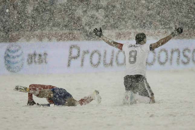 Clint Dempsey of the US asks for a call as Costa Rica’s Michael Barrantes rolls in the snow.