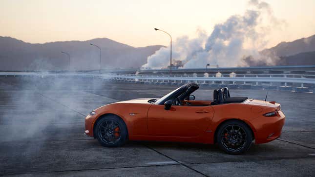 An orange Mazda Miata sports car. 