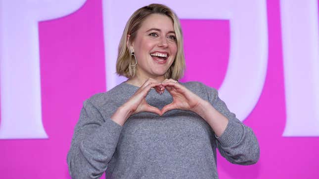 Greta Gerwig makes a heart sign at the Barbie premier. 