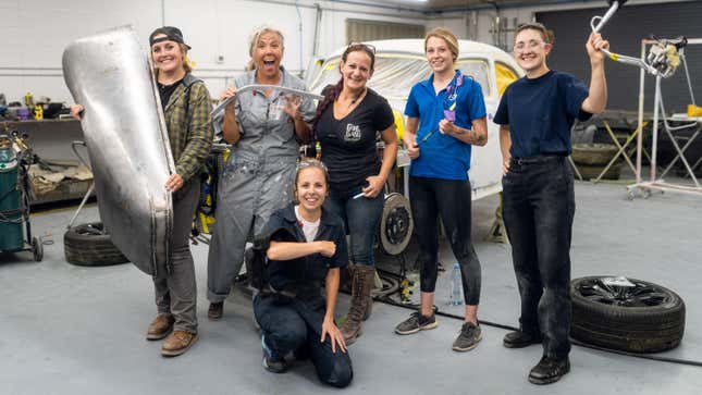 Six women mechanics are in front of a Volvo PV544 