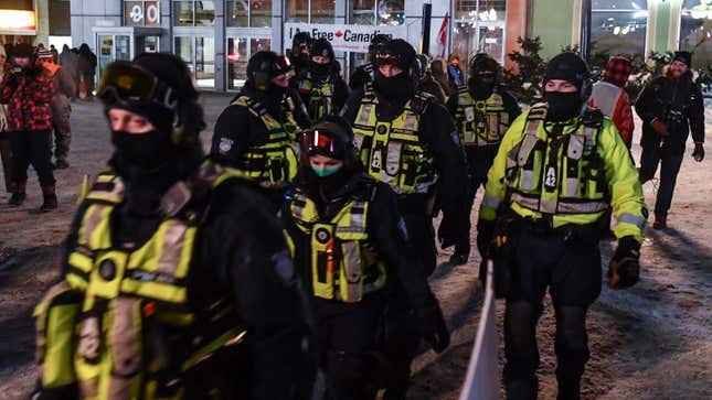 Police march towards Wellington Street on February 5, 2022 in Ottawa, Canada. Truckers continue their rally over the weekend near Parliament Hill in hopes of pressuring the government to roll back COVID-19 public health regulations and mandates.