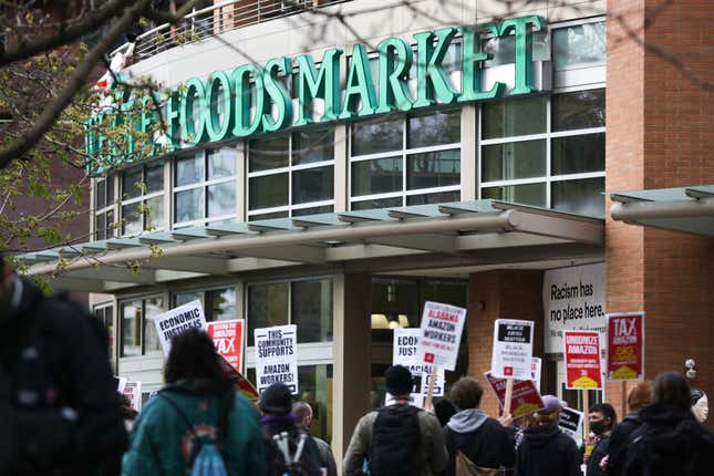 People rally rally outside a Whole Foods Market after marking from Amazon headquarters in solidarity with Amazon workers in Bessemer, Alabama, who hope to unionize, in Seattle, Washington on March 26, 2021. 