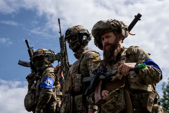 FILE - Fighters of Russian Volunteer Corps stand atop on an APC during press conference not far from the Ukraine&#39;s border with Russia in Sumy region, Ukraine, on May 24, 2023. Fighters from Ukraine made an attempt to cross into the town of Tetkino, which lies right on the border, the governor of Russia’s Kursk region, Roman Starovoit, said Tuesday. (AP Photo/Evgeniy Maloletka, File)