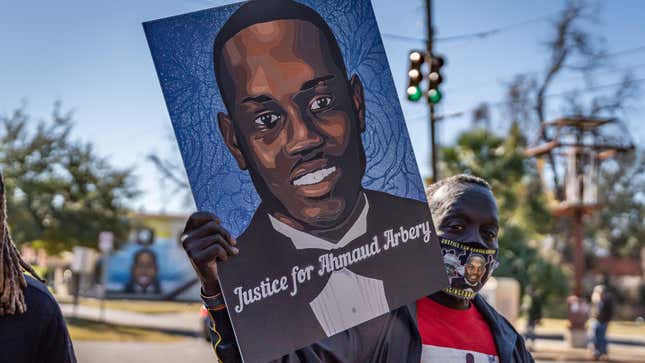 Brunswick, Georgia USA - January 18, 2021: Marcus Arbery, Sr., father of Ahmaud Arbery, carries a portrait of his son in the Rev. Martin Luther King, Jr. Day Parade.