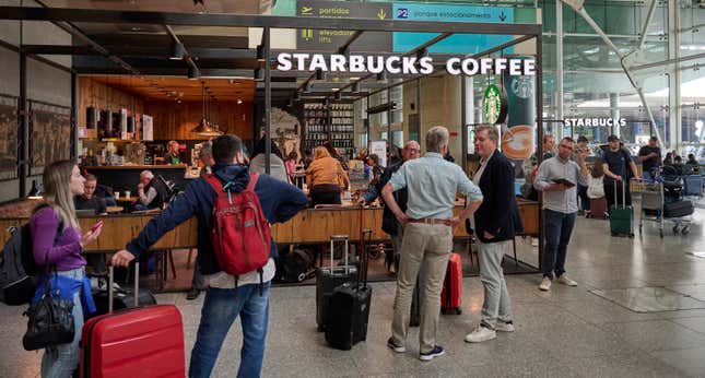 Travelers outside a Starbucks in Humberto Delgado International Airport in Lisbon, Portugal. 